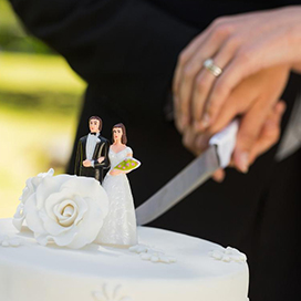 What does cutting the cake at a wedding symbolize?