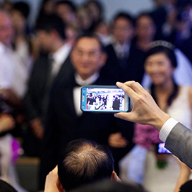 How can we ask people not to take pictures during the wedding ceremony?